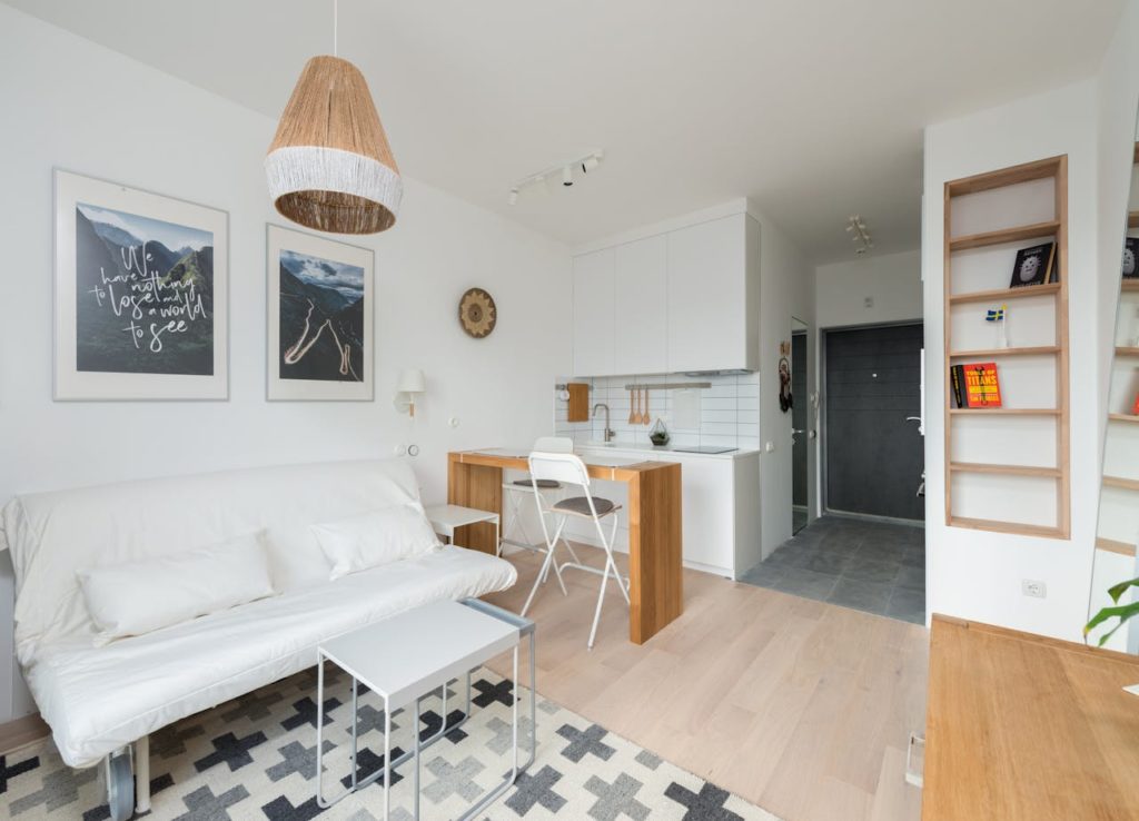 Revente LMNP : comment la réussir ? Photo pour illustrer notre article montrant un appartement étudiant avec canapé-lit, bureau et kitchenette